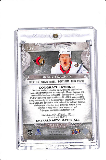 2023-25 UPPER DECK ARTIFACTS BRADY TKACHUK EMERALD AUTO MATERIALS /15 #127